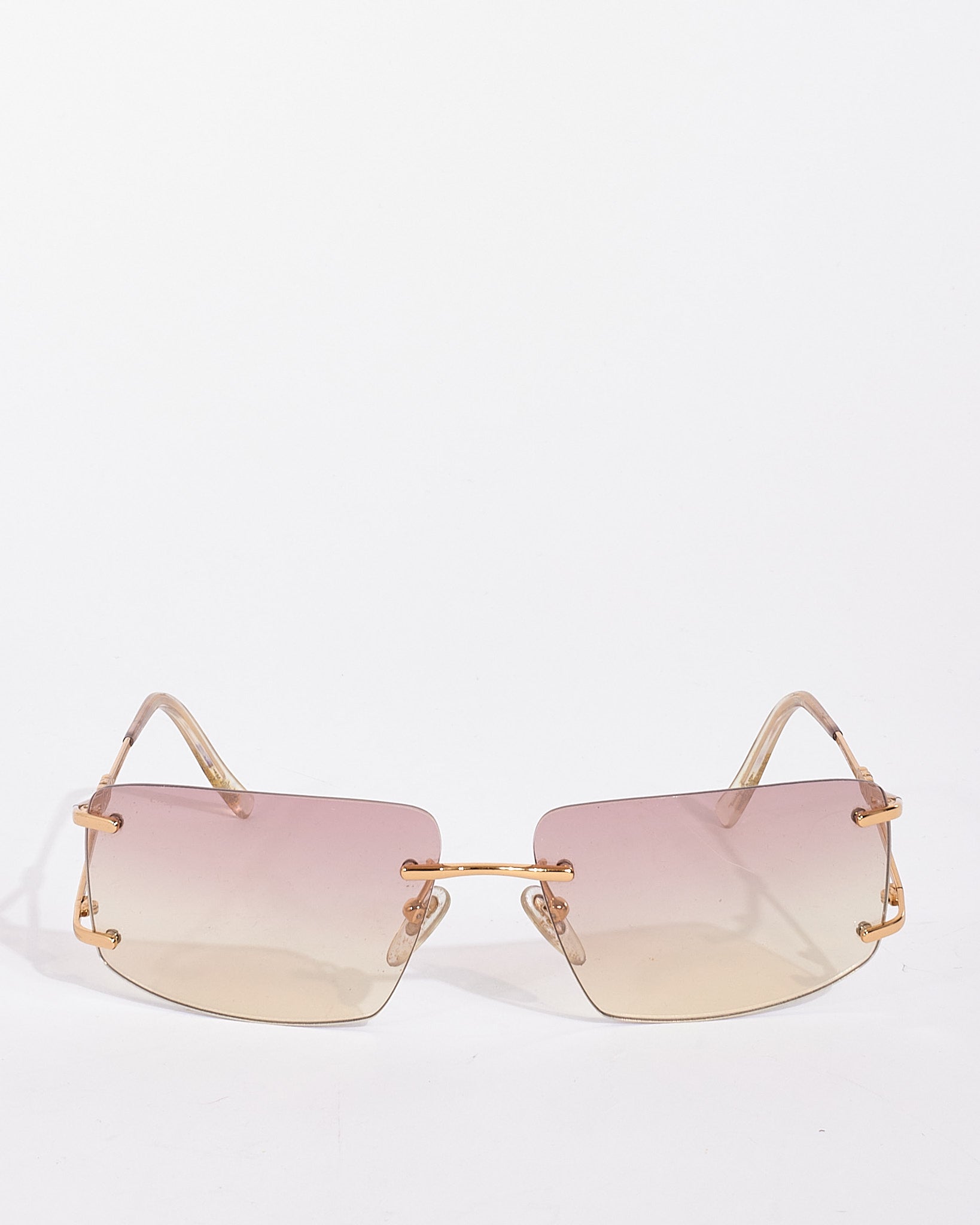 Explore a Salvatore Ferragamo Gold Metal 1071-B Rimless Square