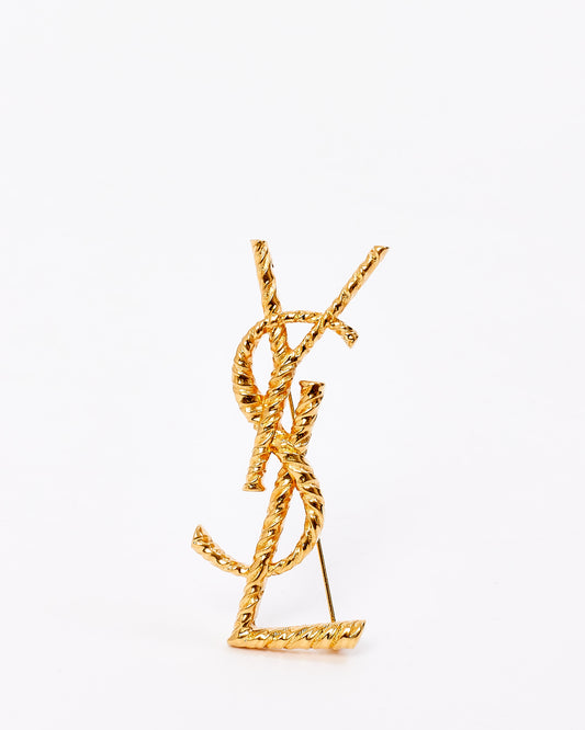 Broche avec logo Opyum torsadé doré Saint Laurent